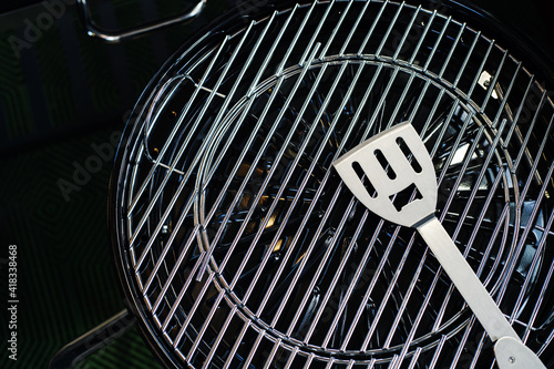 Grill grate and metal spatula. Equipment for cooking on fire and coals. Close-up