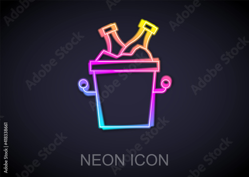 Glowing neon line Beer bottles in ice bucket icon isolated on black background. Vector.