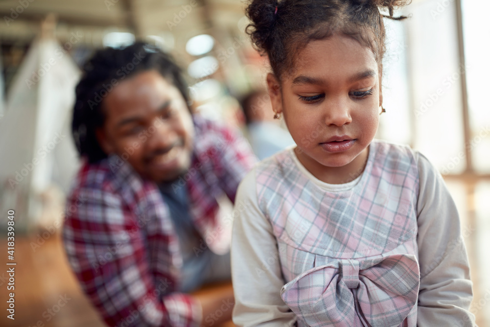 A sweet little girl enjoys with family at home. Family, together, love, playtime A sweet little girl enjoys with family at home. Family, together, love, playtime