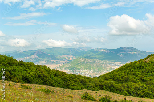 Panorama of the Crimean mountains overlooking the city of Sudak on a sunny day.