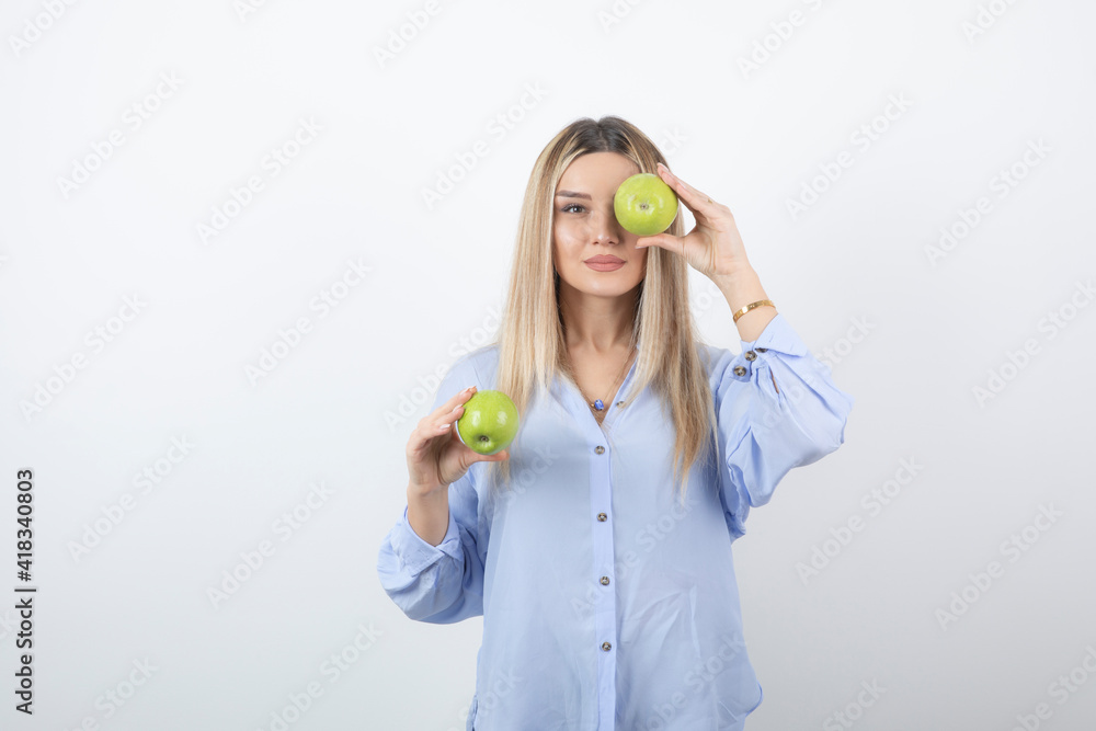Portrait photo of a pretty attractive woman model standing and holding Portrait photo of a pretty attractive woman model standing and holding