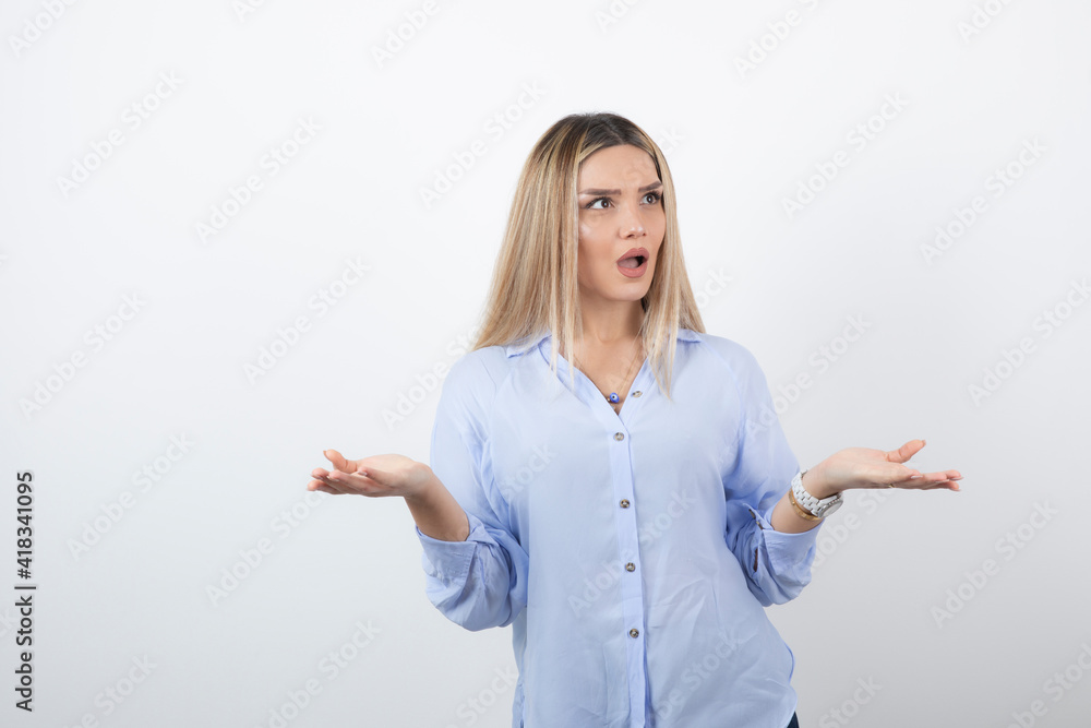 Young woman in casual outfit looking at someone on white background Young woman in casual outfit looking at someone on white background