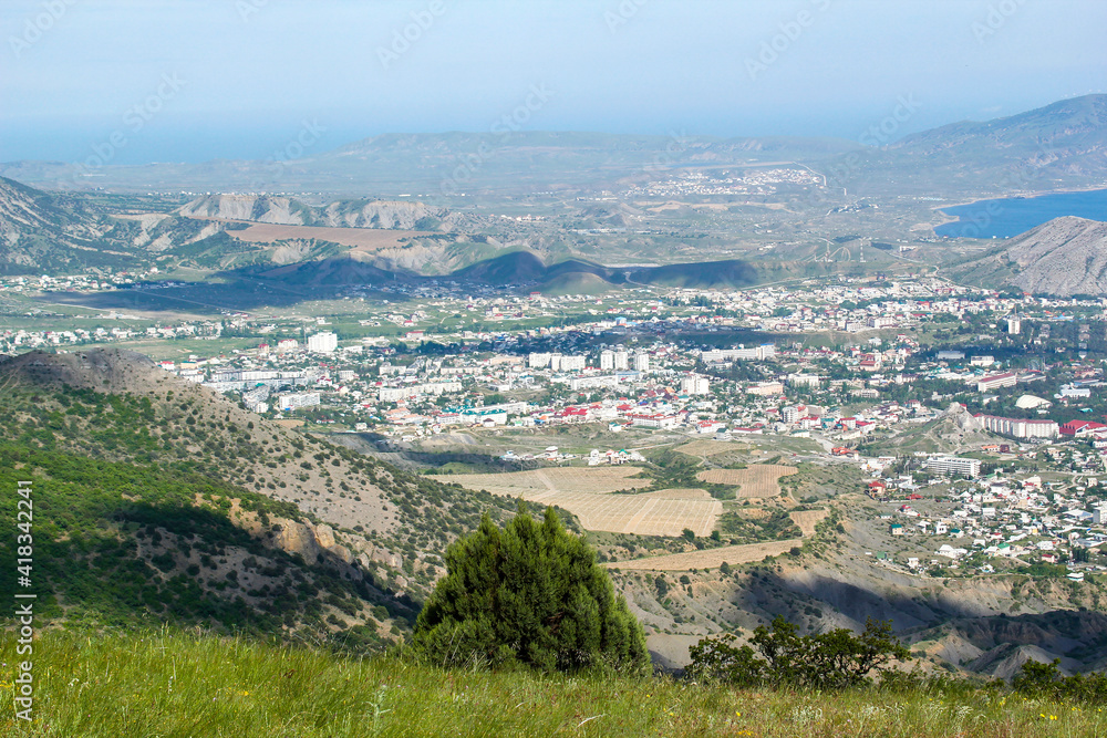 Panorama of the Crimean mountains with a view of the city of Sudak. Fortress view from the mountain on a sunny day.
