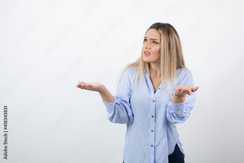Young pretty woman standing and arguing with someone on white background Young pretty woman standing and arguing with someone on white background