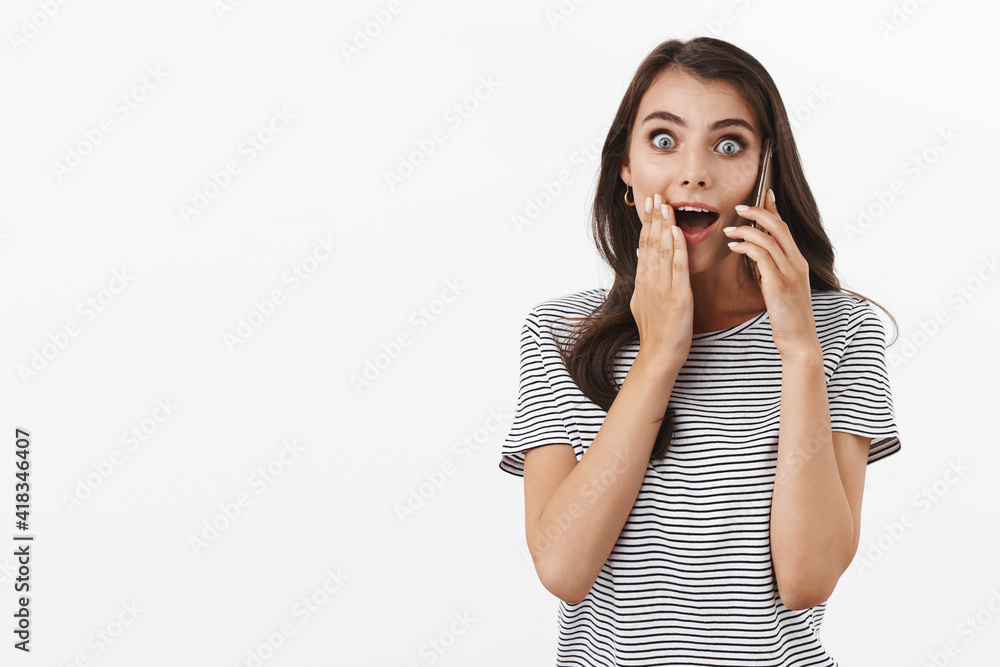 Excited and happy girl surprised, gasping wondered and amused as answer phone call and receive great news, open mouth touch cheek and staring camera impressed, hold smartphone over ear Excited and happy girl surprised, gasping wondered and amused as answer phone call and receive great news, open mouth touch cheek and staring camera impressed, hold smartphone over ear