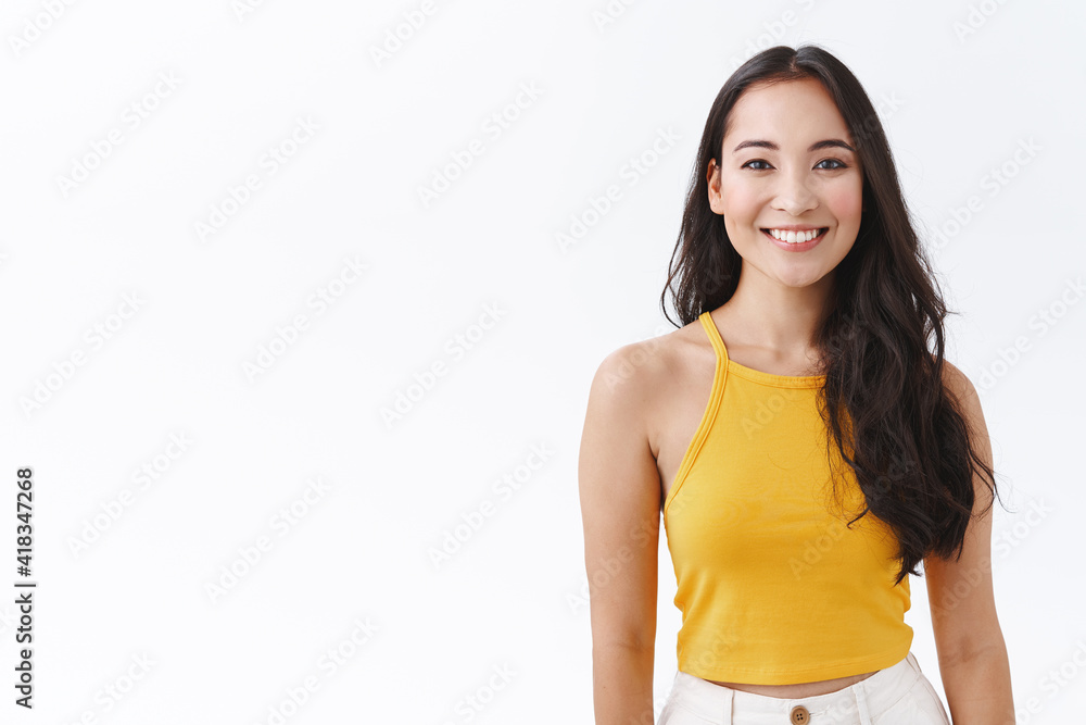Waist-up enthusiastic asian female with long dark hair, wear yellow trendy top, smiling with friendly, carefree expression as looking camera, express positive, joyful emotions, white background Waist-up enthusiastic asian female with long dark hair, wear yellow trendy top, smiling with friendly, carefree expression as looking camera, express positive, joyful emotions, white background