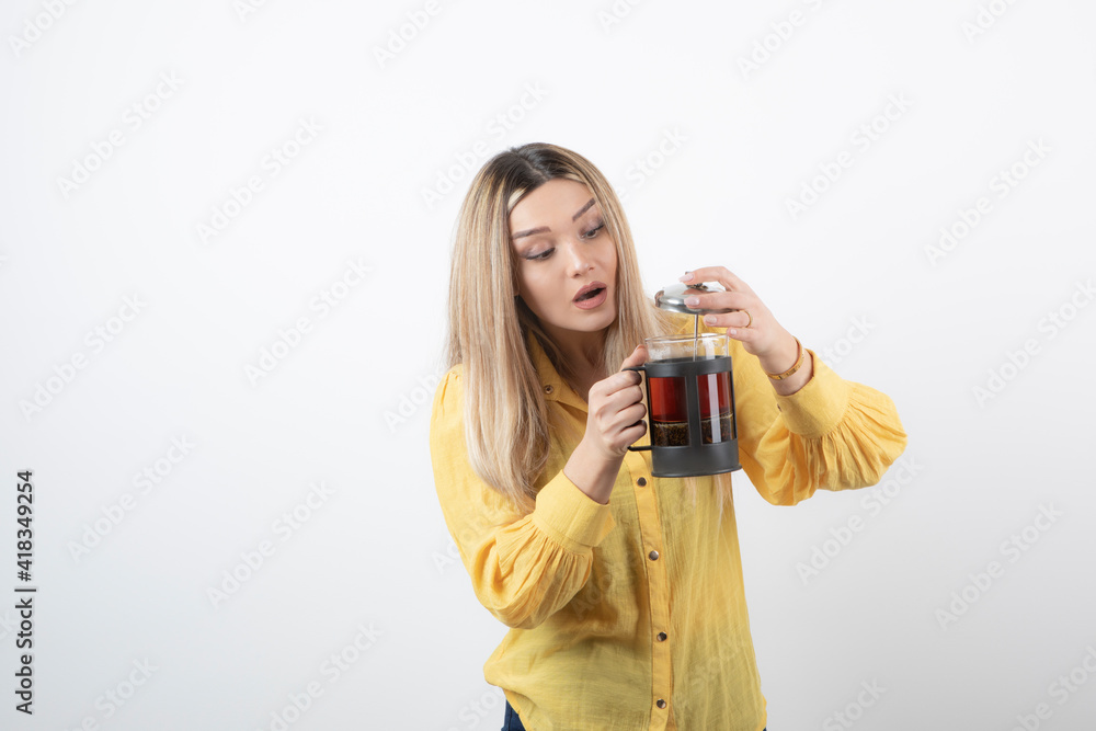 Image of a young pretty woman model holding a teapot Image of a young pretty woman model holding a teapot