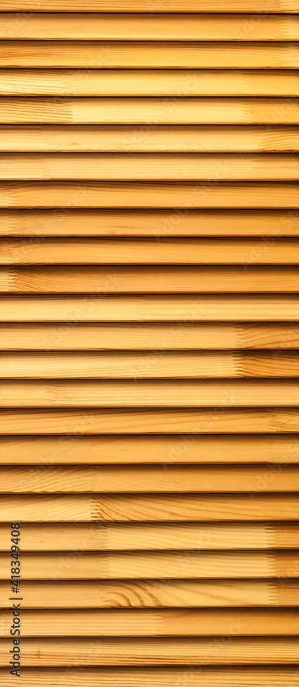 Cabinet door made of stacked wooden boards close-up. Background Cabinet door made of stacked wooden boards close-up. Background