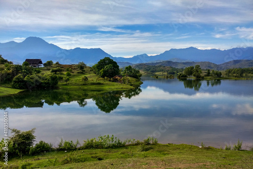 lake and mountains with green grass