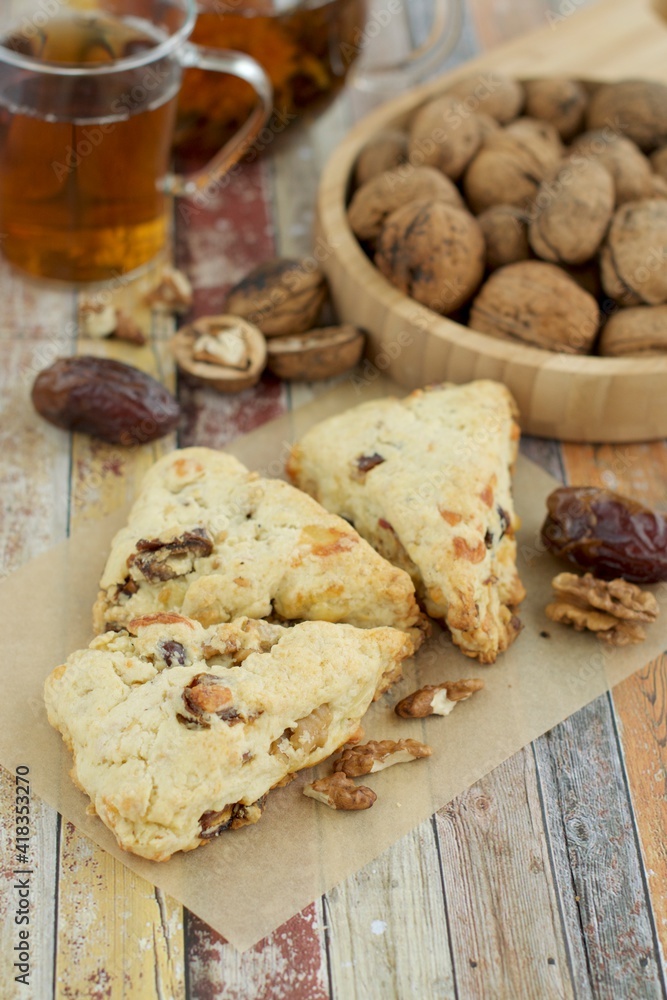 Homemade walnut date scones served with hot tea Homemade walnut date scones served with hot tea