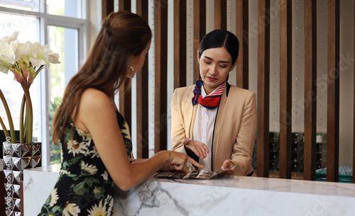 Happiness woman customers are check in to your room at the hotel lobby.