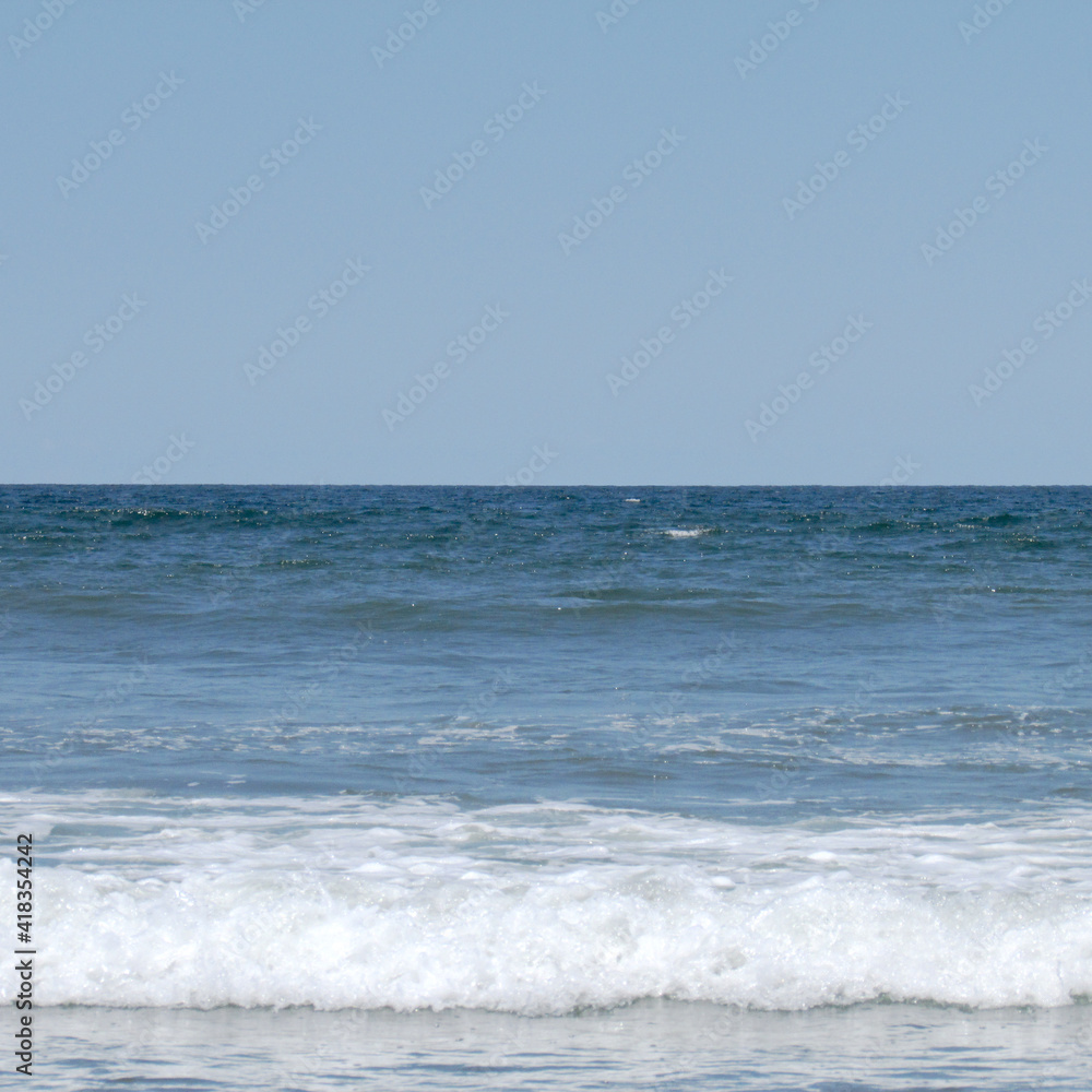 Minimalist landscape. Sea waves. Horizon. Blue sky. Simple background.