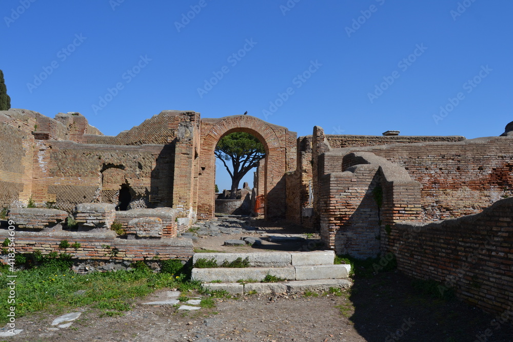 Ancient Roman ruins of houses with brick wall and arches at the archeological site of Ostia Antica Rome Italy 