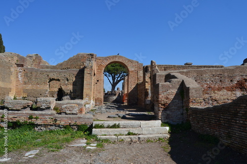 Ancient Roman ruins of houses with brick wall and arches at the archeological site of Ostia Antica Rome Italy 