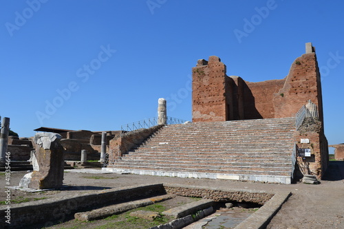 Ruin of capitolium in ancient archeological site of Ostia Antica Rome Italy with brick walls and blue sky