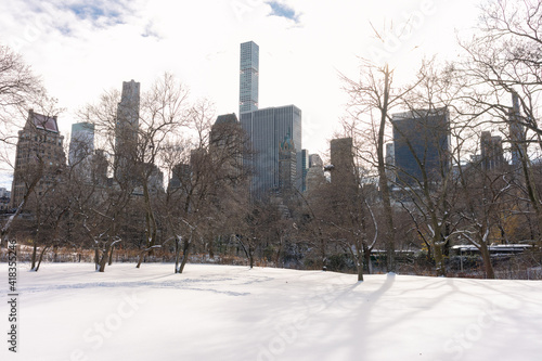 Beautiful Central Park Winter Landscape with Snow and the Midtown Manhattan Skyline in New York City