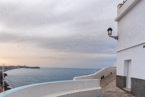 Street and balcony overlooking the sea and Salobreña beach, in the town of La Caleta de Salobreña.