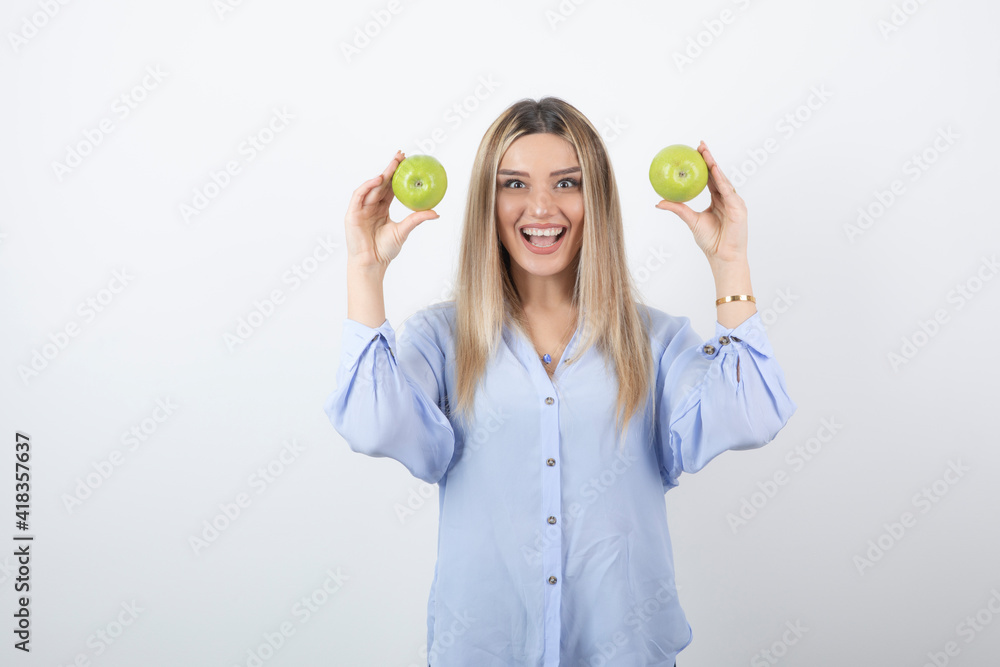 Portrait photo of a pretty attractive woman model standing and holding Portrait photo of a pretty attractive woman model standing and holding