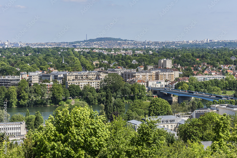 Beautiful view of valley of Seine River and panorama of Paris on backgrounds from lookout in city Saint-Germain-en-Laye (13 miles west of Paris). Saint-Germain-en-Laye, France.