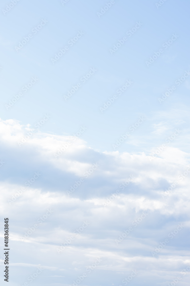 Natural background with light blue spindrift clouds. Abstract vertical backdrop Natural background with light blue spindrift clouds. Abstract vertical backdrop