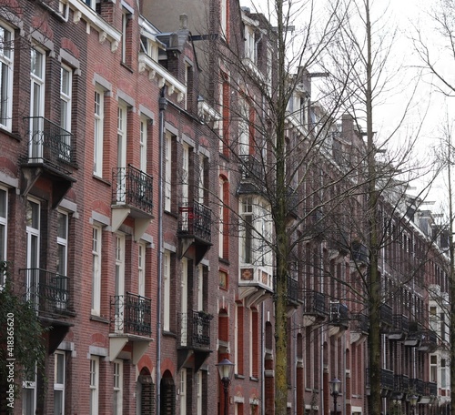 Amsterdam House Facades with Balconies and Winter Trees