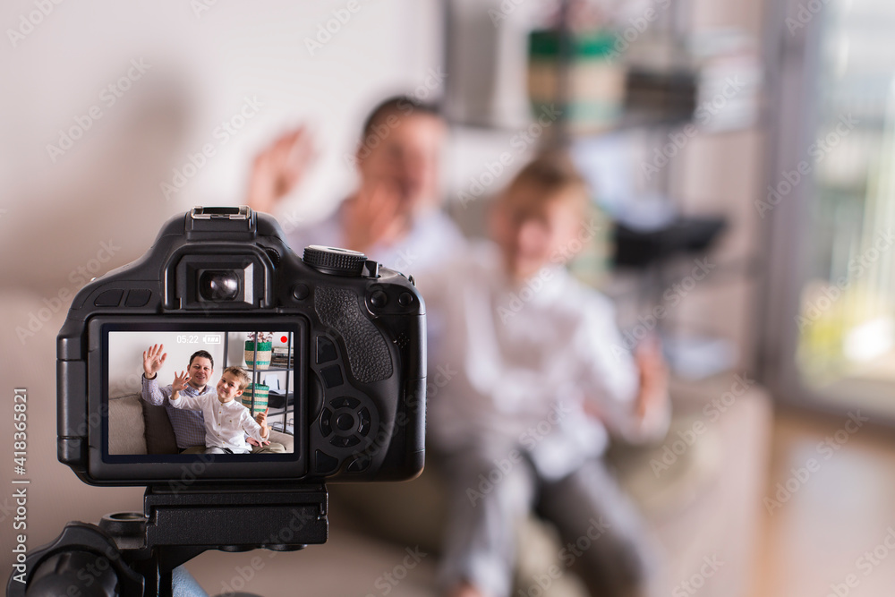 Vlogger family recording social media video while sitting on couch Vlogger family recording social media video while sitting on couch