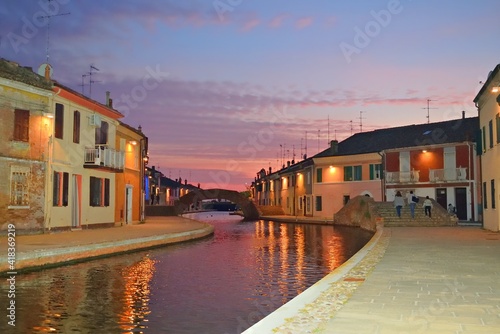 landscape of the characteristic village of Comacchio at sunset time. It is a historic Italian lagoon village also called little Venice, in the province of Ferrara in Emilia Romagna
