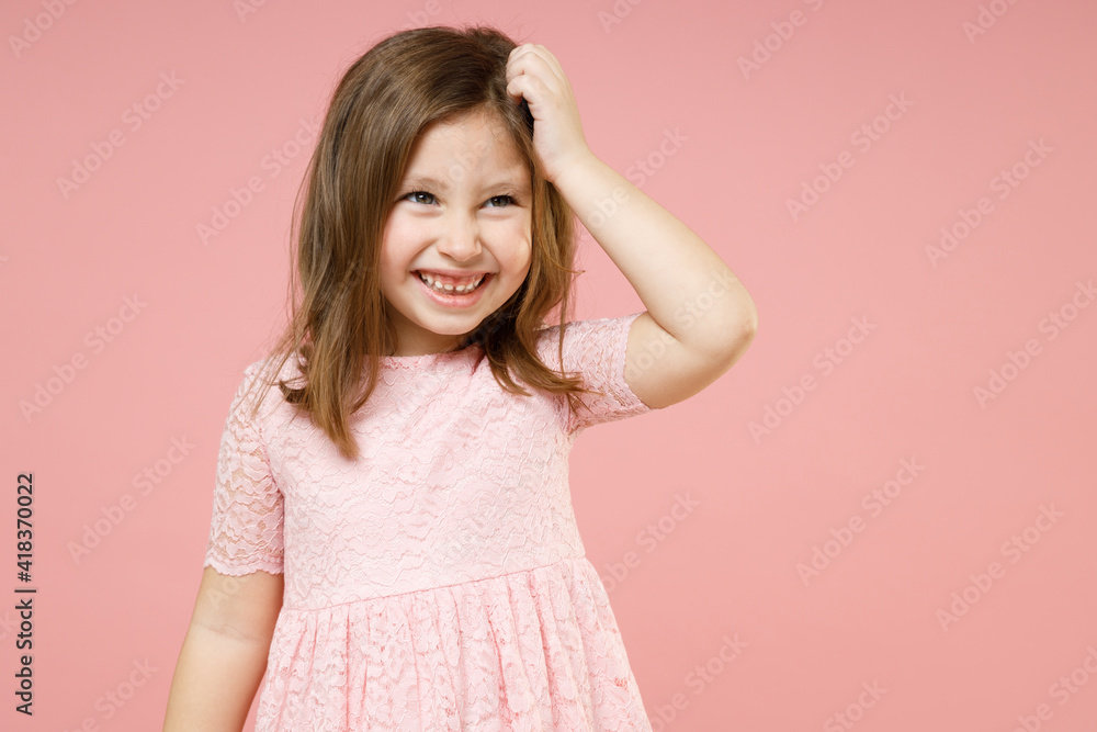 Little thoughtful cute kid girl 5-6 years old wears rosy dress have fun put hand on head isolated on pastel pink background child studio portrait. Mother's Day love family childhood lifestyle concept. Little thoughtful cute kid girl 5-6 years old wears rosy dress have fun put hand on head isolated on pastel pink background child studio portrait. Mother's Day love family childhood lifestyle concept.