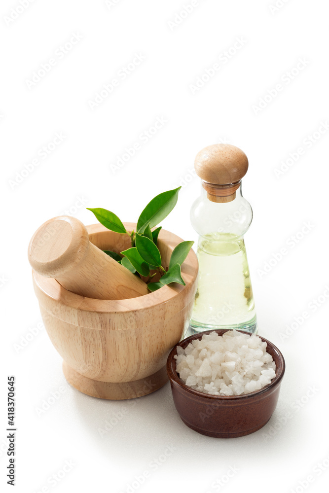 close up view of mortar, salt and bath oil on white back. close up view of mortar, salt and bath oil on white back.