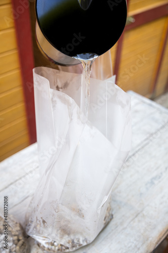 boiled water is added to a bag full of straw pellets and gypsum
