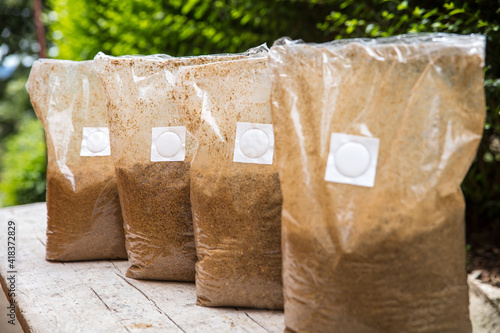 group of bags with straw substrat in it, prepared for mushroom cultivating