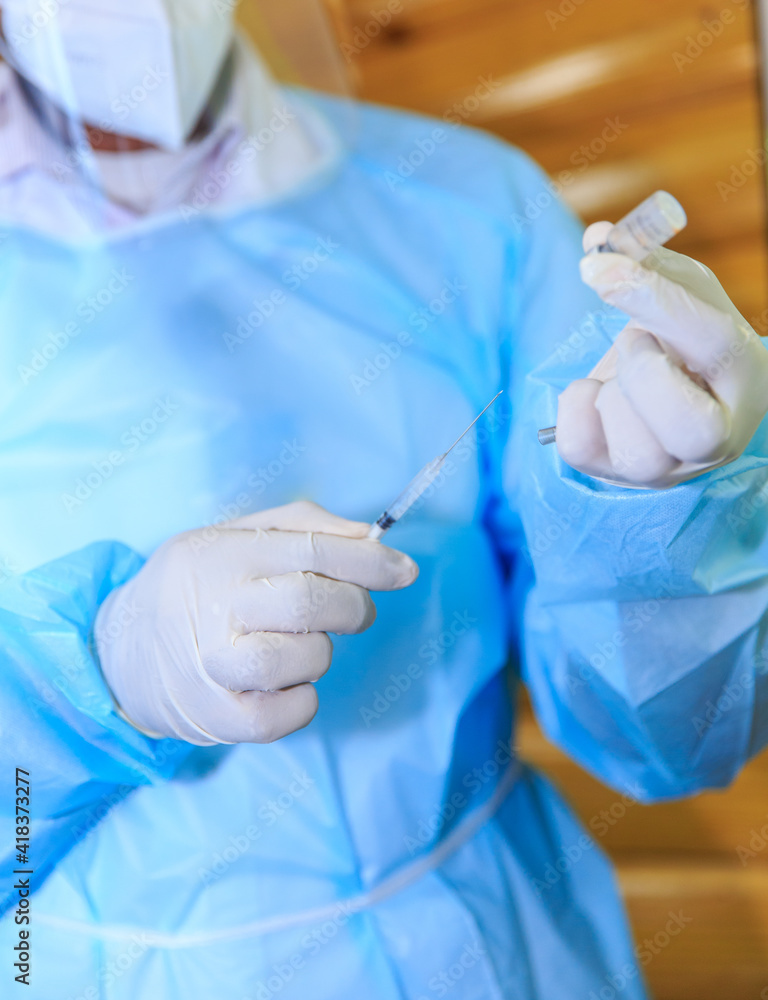 Covid-19 vaccine, doctor with syringe