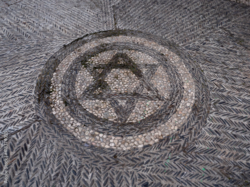 cobblestone pavement with geometric star and structure in the Albaicin, Granada, Spain