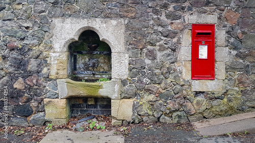 Fotografie, Obraz Malvern spring water well and postbox on Welland Road Malvern Worcestershire uk