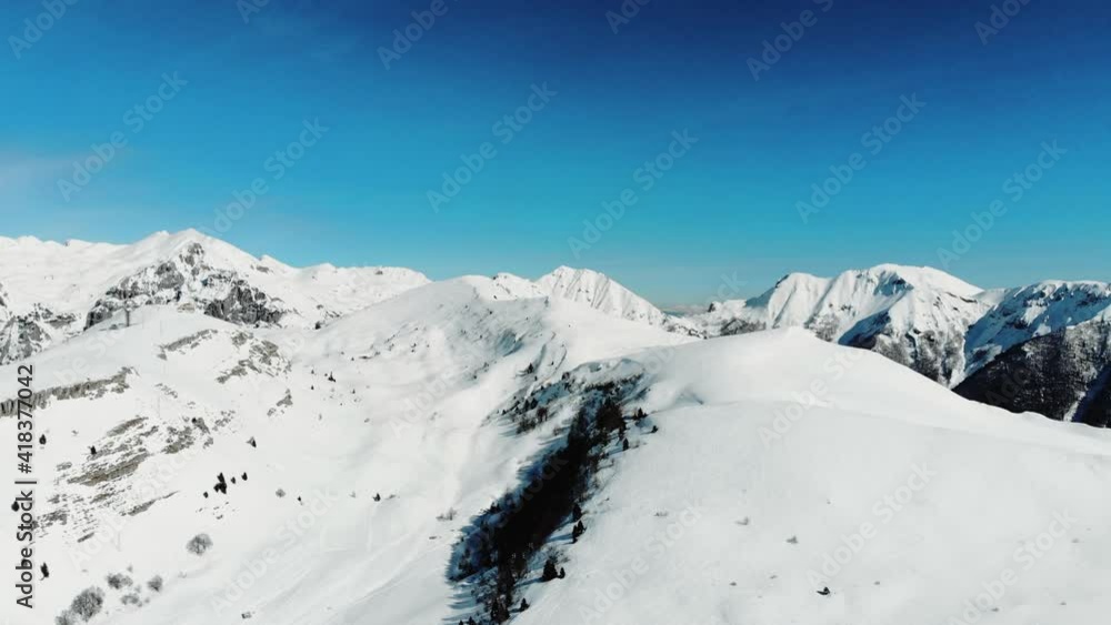 Aerial view of the Italian alps, mountains with snow. Scenic Small Town. Aerial view of the Italian alps, mountains with snow. Scenic Small Town.