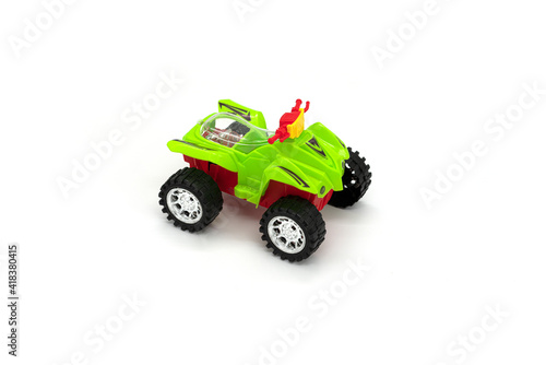 Plastic ATV toy isolated on white background.