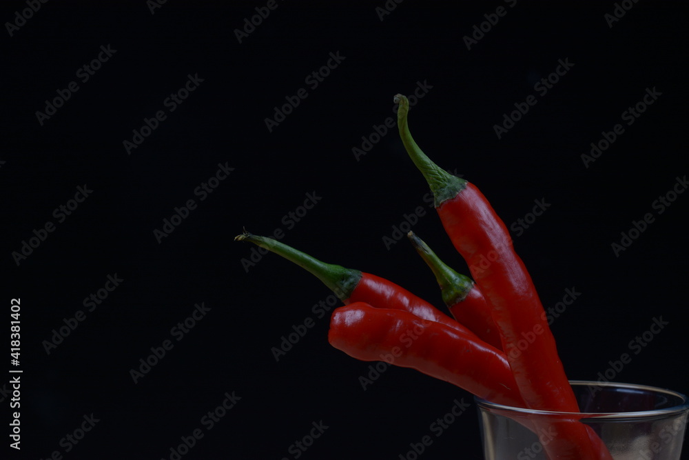 red long lombok on black background. ingredients for food seasonings. red long lombok on black background. ingredients for food seasonings.