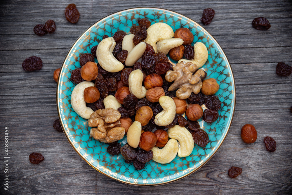 mix of various nuts and raisins on a plate top view mix of various nuts and raisins on a plate top view