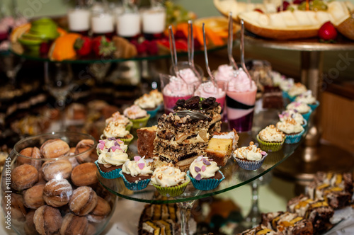 Sweet cakes at a wedding banquet. Catering  sweet festive buffet. Candy bar