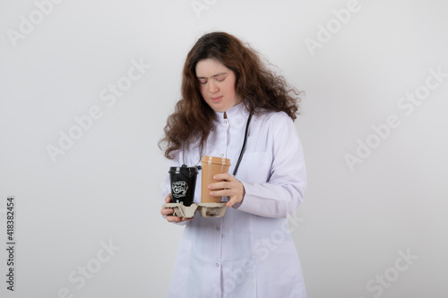 Picture of a young girl model in white uniform holding a cardboard