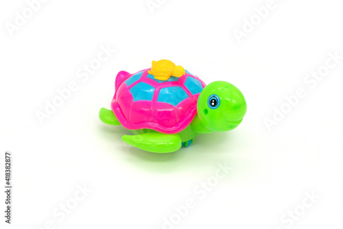 Plastic turtle toy isolated on white background.