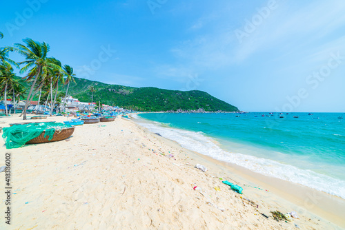Fototapeta Naklejka Na Ścianę i Meble -  Secluded tropical beach turquoise transparent water palm trees, Bai Om undeveloped bay Quy Nhon Vietnam central coast travel destination, desert white sand beach