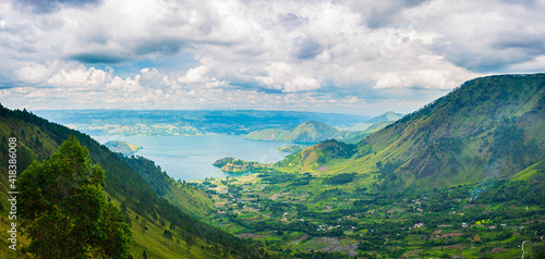 Lake Toba and Samosir Island view from above Sumatra Indonesia. Huge volcanic caldera covered by water, traditional Batak villages, green rice paddies, equatorial forest.