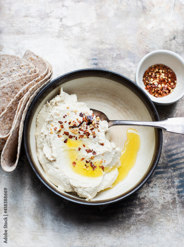 Pita bread with hummus dip, chilli flakes Pita bread with hummus dip, chilli flakes