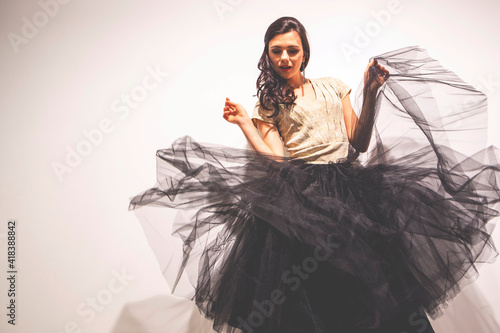 Woman holding tulle skirt dancing
