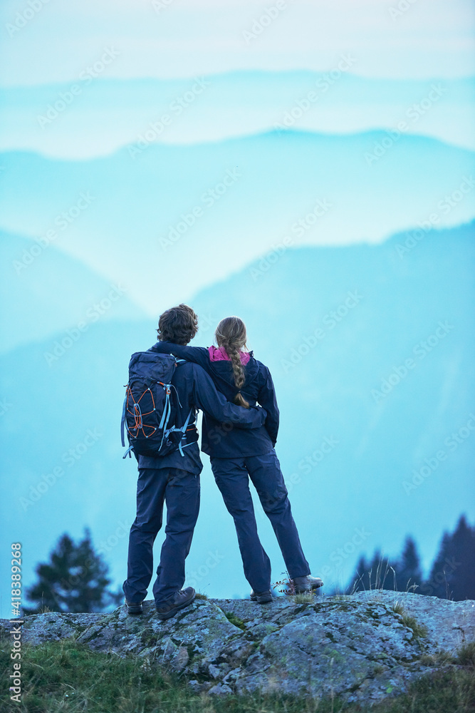 Hikers enjoying view of misty mountains, Manigod, Rhone-Alpes, France Hikers enjoying view of misty mountains, Manigod, Rhone-Alpes, France