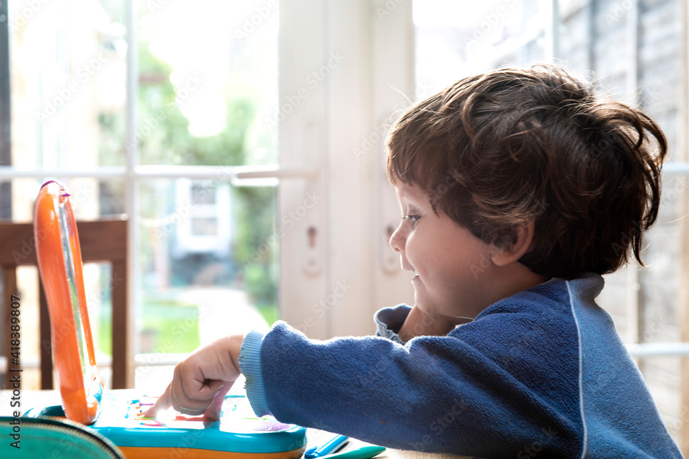 Toddler boy using toy laptop Toddler boy using toy laptop