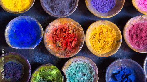 Vibrant pigment powder in clay dishes photo