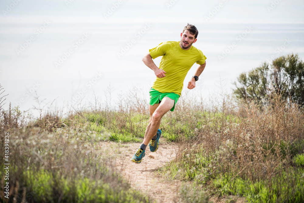 Runner jogging on cliff top, Santa Barbara, California, USA Runner jogging on cliff top, Santa Barbara, California, USA