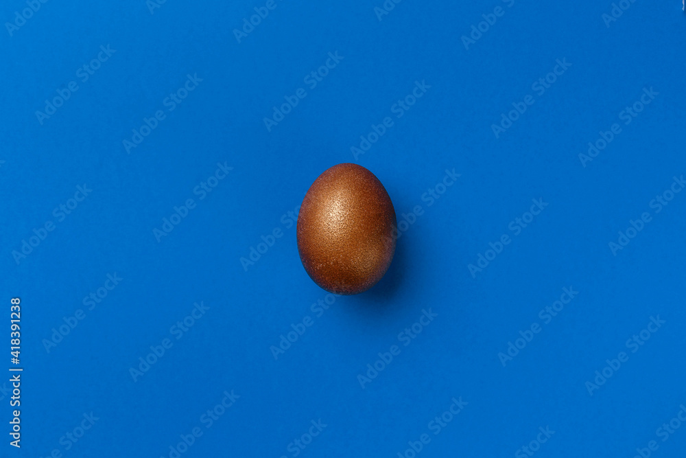 Golden modern easter eggs on a blue background. Easter concept. Isolated. Golden modern easter eggs on a blue background. Easter concept. Isolated.